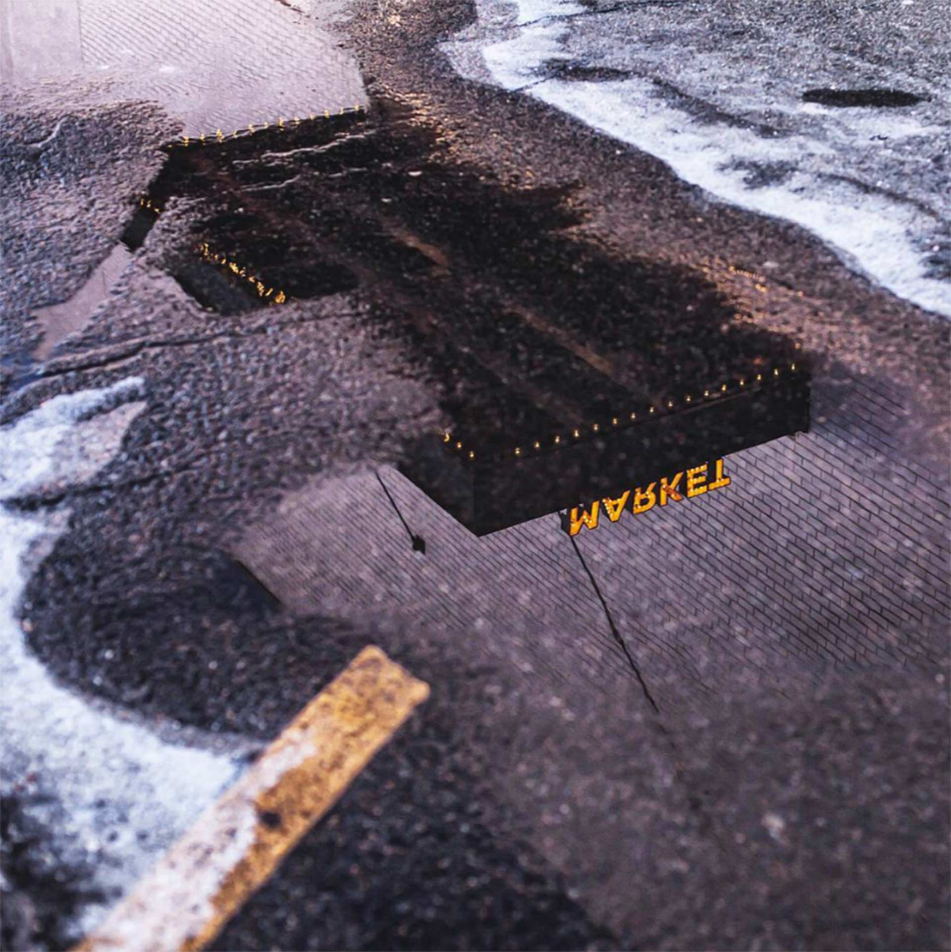 market sign reflected in puddle