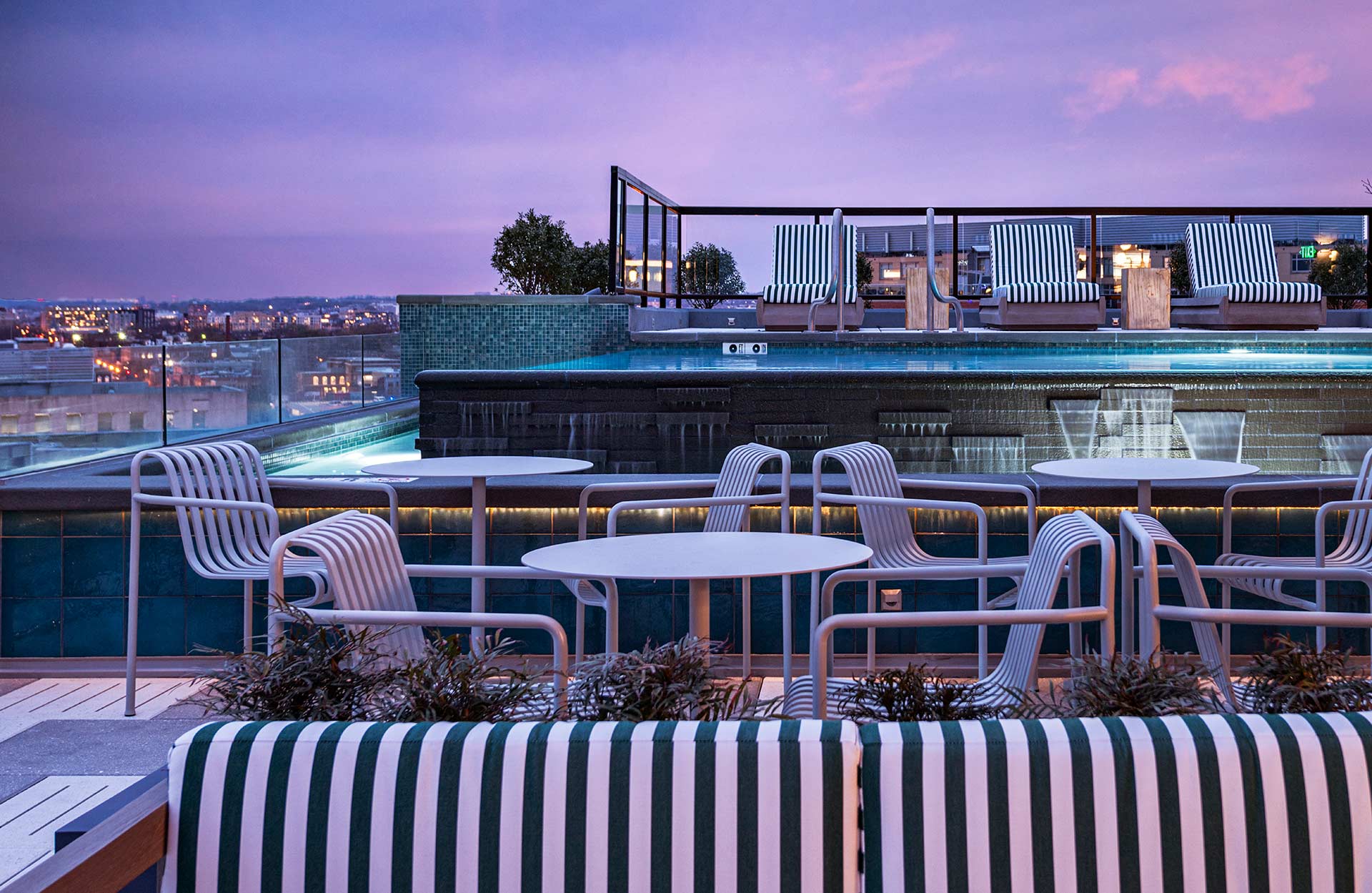 outdoor rooftop seating in front of infinity pool at dusk