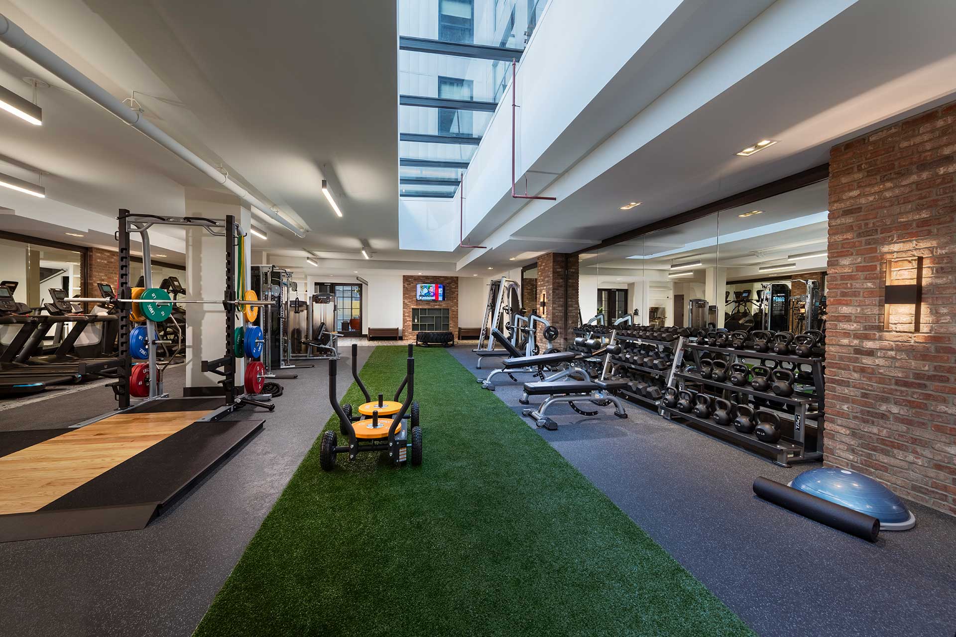 gym with free weights and turf flooring