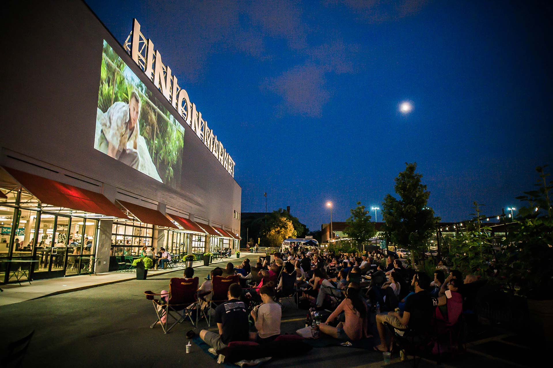 crowd watching outdoor movie at union market 
